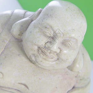 微笑的佛祖雕像佛教徒祷告雕刻石头精神雕塑白色崇拜上帝背景图片