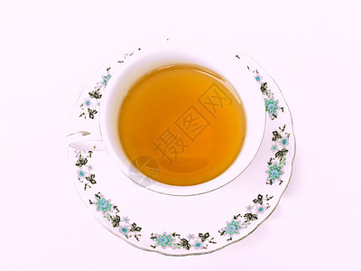 一杯茶 用白色背景隔绝的花粉形态草本玻璃棕色杯子液体早餐盘子时间饮料花朵图片