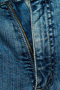 蓝色牛仔裤古董服饰裤子标签宏观缝合衣服帆布纺织品接缝图片