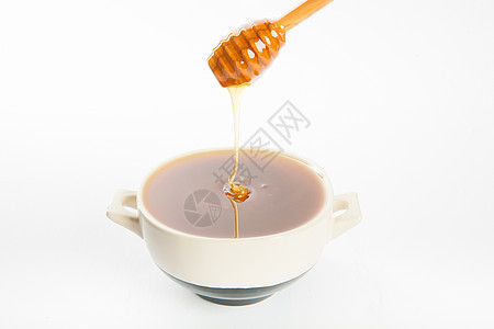 杯子和勺子里多汁的蜂蜜甜点产品木头玻璃金子美食液体健康饮食流动静物图片