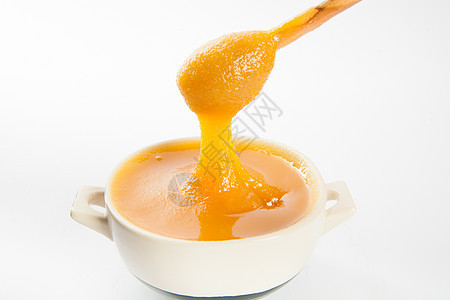 杯子和勺子里多汁的蜂蜜营养木头甜点产品蜜蜂玻璃流动液体金子美食图片