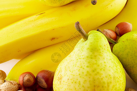白背景的香蕉 梨和坚果榛子水果黄色花生小吃白色夫人食物核桃公爵图片
