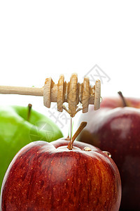 粘贴在白色上孤立的蜂蜜和苹果木头花絮液体酱料金子勺子棕色文化工作室美食图片