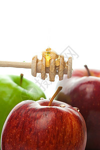 粘贴在白色上孤立的蜂蜜和苹果液体黄色勺子棕色糖浆文化蜜蜂水果食物金子图片