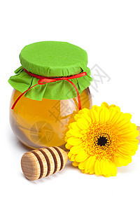 紧紧粘在白色上隔着的蜂蜜 花和罐子养分药品食物植物香味丝带玻璃树叶雏菊洋甘菊图片