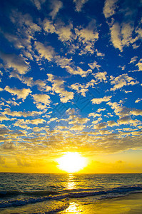 日落在海面上地平线日光海洋波浪反射太阳蓝色射线阳光橙子图片