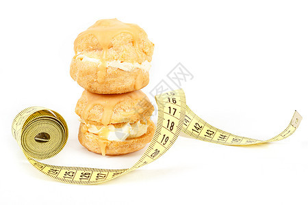 缩水 焦糖蛋糕和测量胶带的概念团体奶油营养磁带面包食物重量味道蛋糕糕点图片