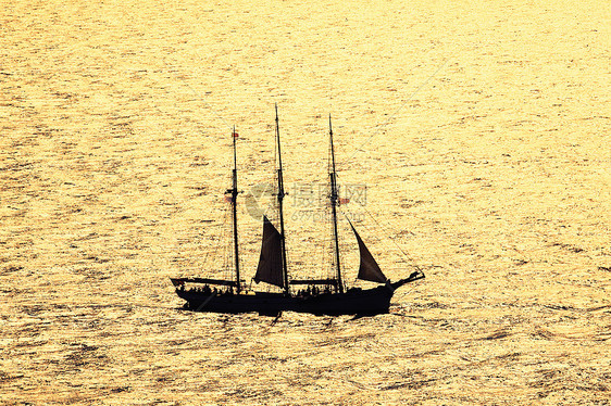 日落时出航海浪天空自由反射海洋游客游艇金子海岸海景图片