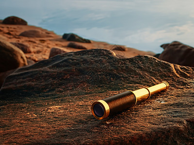 古董黄铜望远镜石头海岸线海盗岩石海岸工具镜片海滩单目管子背景图片
