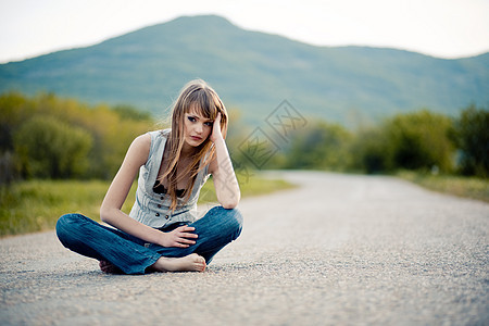 坐在路上的少女思维厌倦乡村悲伤沥青场景青少年孤独赤脚牛仔裤图片