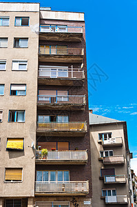 欧洲对抗蓝天通用公寓楼的蓝色平面灰色障碍窗户建筑学生活财产天空玻璃酒吧白色图片
