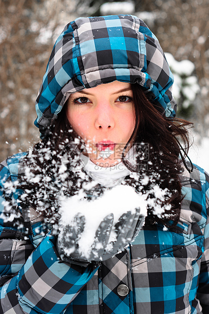 迷人的年轻女子手握雪雪女孩微笑女士衣服蓝色照片围巾降雪天气女孩们图片