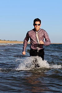 勇敢的商务人士勇气眼镜海岸线跑步男人海浪蓝色男性色调阳光图片