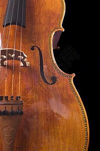 黑色背景的大提琴光泽度作品独奏合奏乐器木头细绳采摘乐队音乐家图片