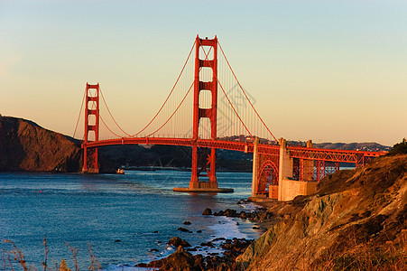 日落时金门桥悬崖收费运输电缆支撑旅游蓝色旅行橙子海洋图片
