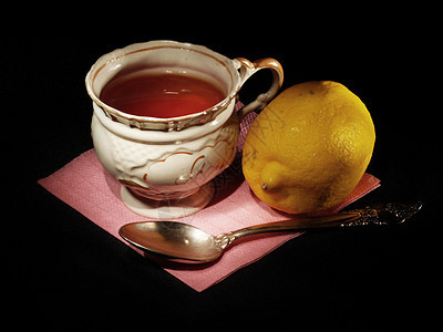 一杯茶时间早餐黑色餐巾茶碗杯子茶匙柠檬白色勺子图片