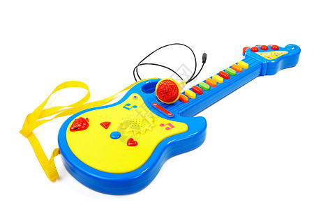 儿童玩具吉他和麦克风在白色的背面被孤立黄色蓝色幼儿园闲暇玩物土地塑料游戏音乐童年图片