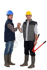 握手的两个体力工人投资者微笑螺栓商业木匠协议讨论刀具就业建筑师图片
