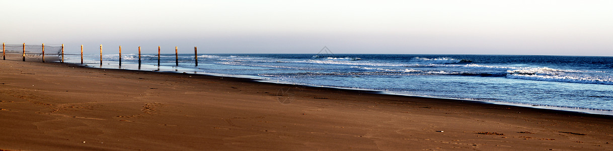 海滩栅栏海浪金子海景蓝色热带天气地平线晴天旅行阳光图片