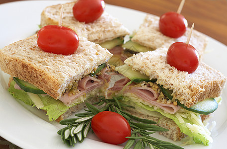 美味的俱乐部三明治全麦面包桌子小吃折叠午餐牙签木板叶子调味品晚餐火腿图片