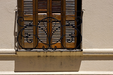 旧窗口格子和阴影锁定历史黄铜柱子灌木丛棕色阳台石工黑色石头图片