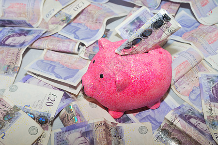 带纸钞的猪银行陶器笔记粉色小猪背景图片