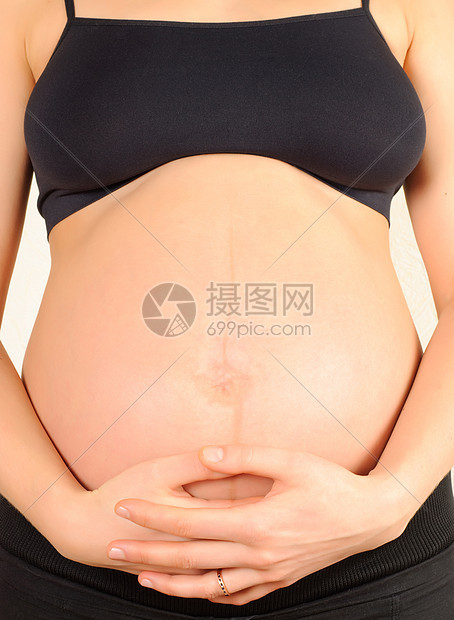 怀着肚子的怀孕妇女婴儿手臂胸部生活分娩女士女性化药品母性父母图片