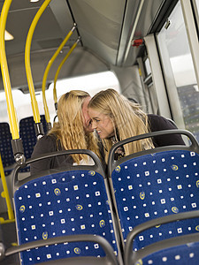 公共汽车上的妇女女孩们座椅车辆椅子朋友们交通金发驾驶旅行陆地图片