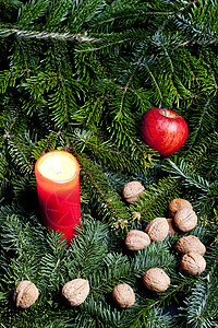 圣诞苹果蜡烛圣诞节还带着蜡烛过着圣诞核桃符号静物水果传统食物内饰坚果背景