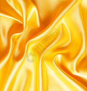 平滑优雅的金色西边作为背景黄色版税金子涟漪纺织品感性投标丝绸布料材料图片