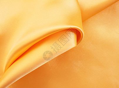 平滑优雅的金色丝绸作为背景黄色材料折痕感性布料投标纺织品涟漪反光金子图片