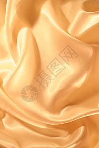平滑优雅的金色西边作为背景丝绸金子涟漪黄色奢华折痕织物材料投标婚礼图片