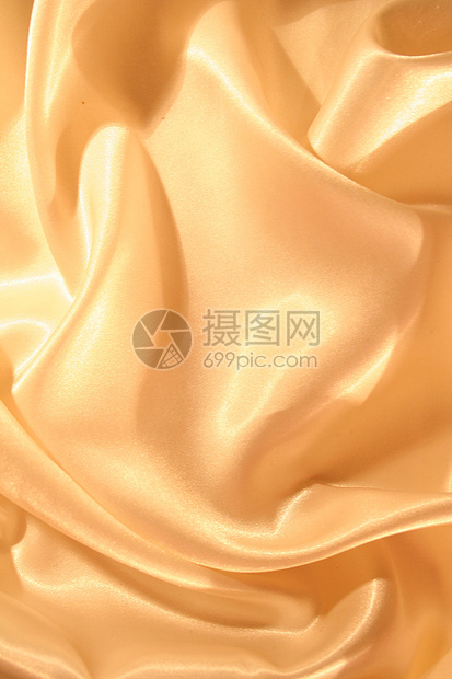 平滑优雅的金色西边作为背景丝绸金子涟漪黄色奢华折痕织物材料投标婚礼图片