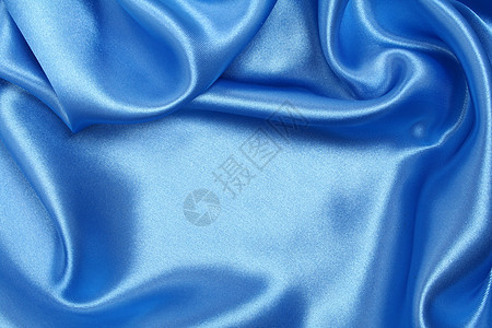 平滑优雅的蓝色丝绸作为背景海浪材料织物曲线银色折痕布料投标纺织品图片