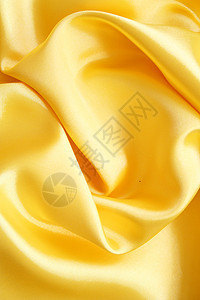 平滑优雅的金金丝绸折痕曲线涟漪黄色布料纺织品海浪材料投标织物图片