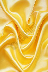 平滑优雅的金金丝绸折痕材料黄色布料曲线丝绸涟漪投标织物海浪图片
