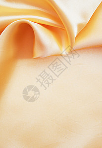 平滑优雅的金色丝绸作为背景金子曲线布料织物黄色投标涟漪纺织品折痕材料图片