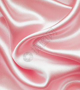 平滑优雅的粉色丝绸作为背景纺织品织物海浪曲线银色折痕材料投标布料图片