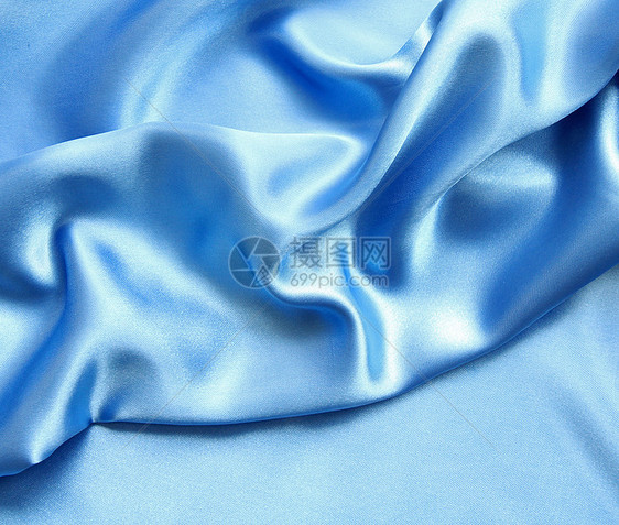 平滑优雅的蓝色丝绸作为背景布料纺织品折痕投标材料织物海浪曲线银色图片