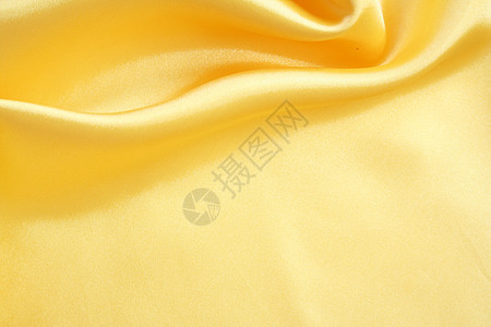 平滑优雅的金金丝绸折痕布料织物纺织品材料曲线黄色投标海浪涟漪图片