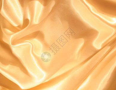 平滑优雅的金金丝绸折痕曲线丝绸纺织品黄色海浪材料投标涟漪织物图片