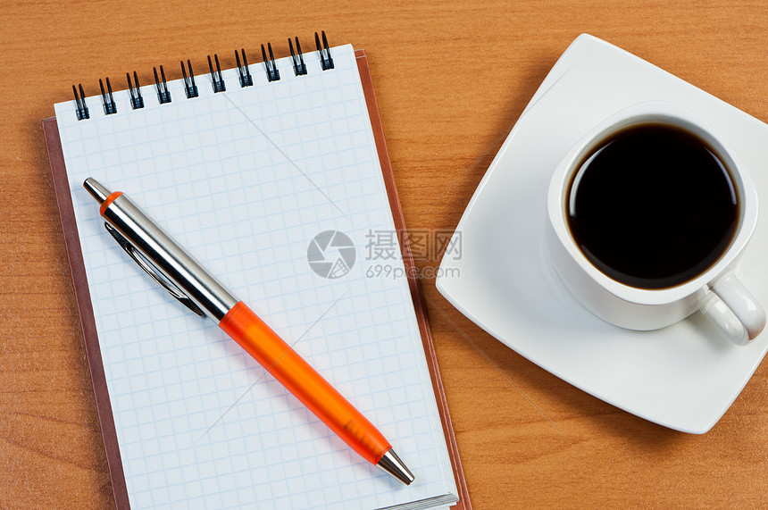 用笔记本和咖啡写在表顶视图上的笔记本图片