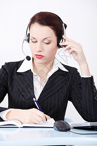 戴耳机的女商务人士商业工作写作成功工人女士电话职场女性办公室图片