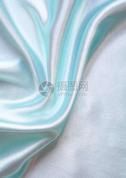 平滑优雅的蓝色丝绸作为背景折痕投标纺织品材料版税银色感性织物布料生产图片
