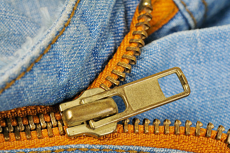 牛仔裤口袋的拉链衣服接缝铆钉服装面料纺织品压缩时尚纹理棉布图片