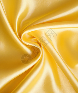 平滑优雅的金色西边作为背景材料婚礼织物纺织品布料奢华折痕投标涟漪黄色图片