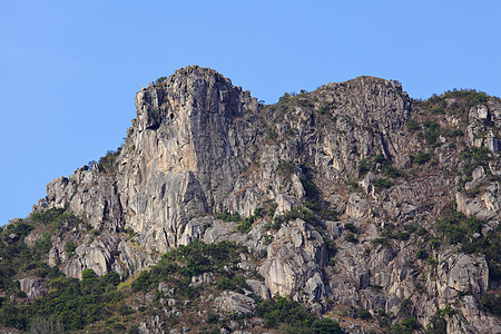 香港的狮子石晴天狮子蓝色市中心天空精神岩石爬坡头脑绿色图片