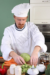 在厨房准备午餐的年轻厨师美食餐厅职业男性蔬菜衣服工作帽子服务白色图片