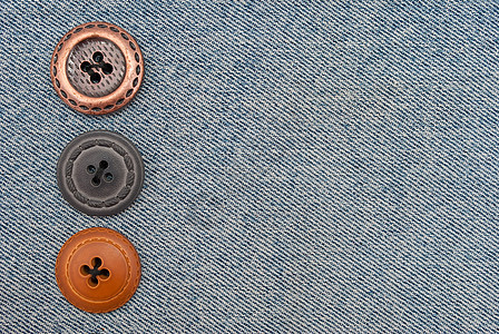 牛仔裤按钮接缝织物帆布纤维衣服材料牛仔布棉布纺织品宏观图片