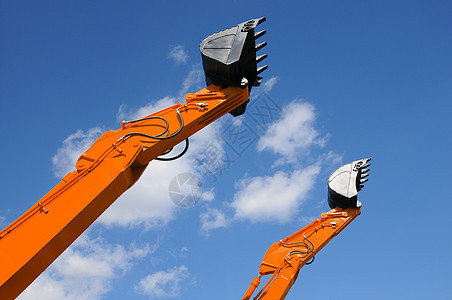 蓝色天空对面的推土机铲橙子车辆机械工作机器液压构造工业刮刀搬运工背景图片